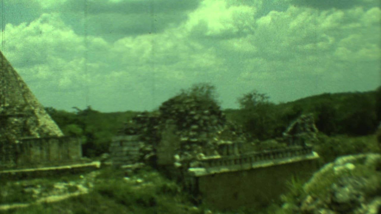 Temple-like stone structures and ruined masonry surrounded by low greenery.