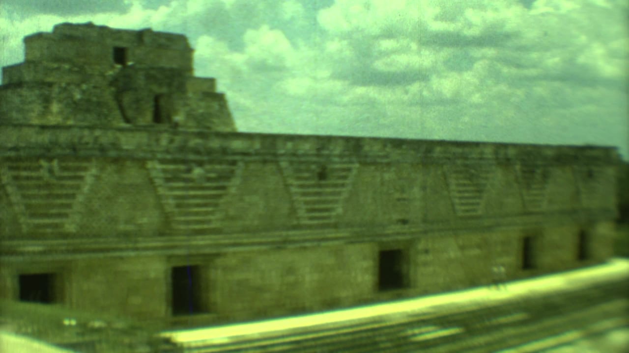 Large stone ruin with stair details and dark doorways.