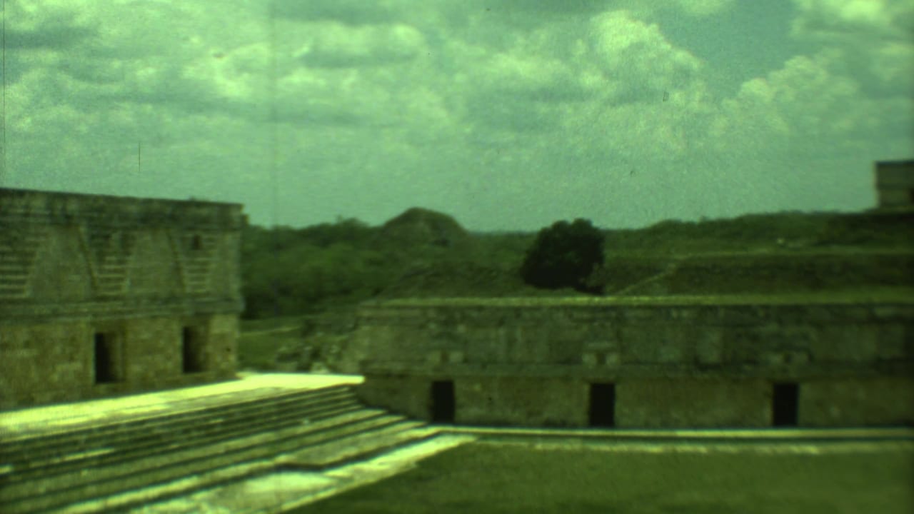 Stepped stone platform and low ruin walls seen across an open courtyard.