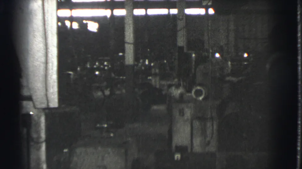 A darker 1939 Cleveland warehouse angle shows a large column, clustered machines, scattered objects, and barely visible workers.