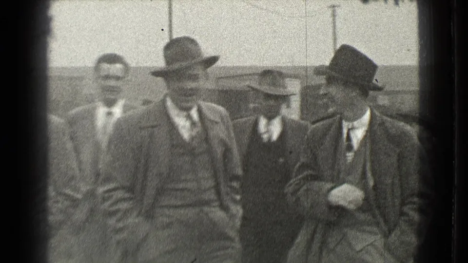 Four adult men in suits and brimmed hats stand together outdoors in Cleveland, Ohio, in 1939 footage.