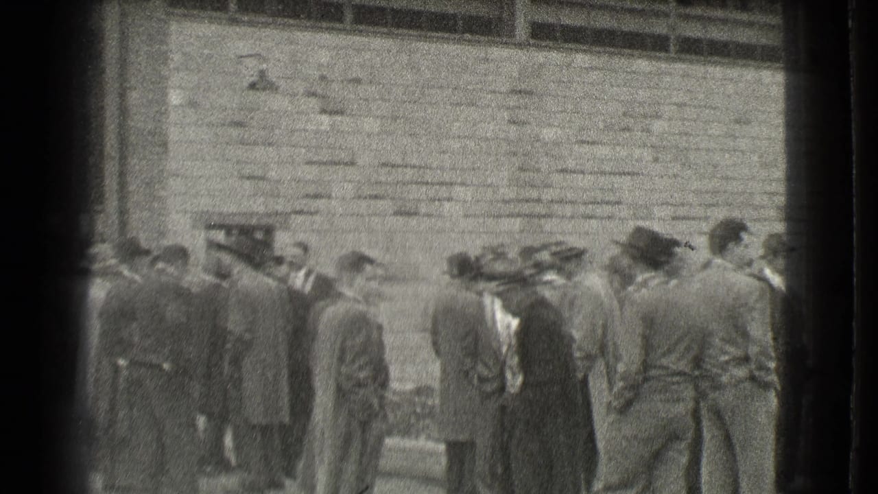 Men in suits and hats gather outside a masonry building entrance.