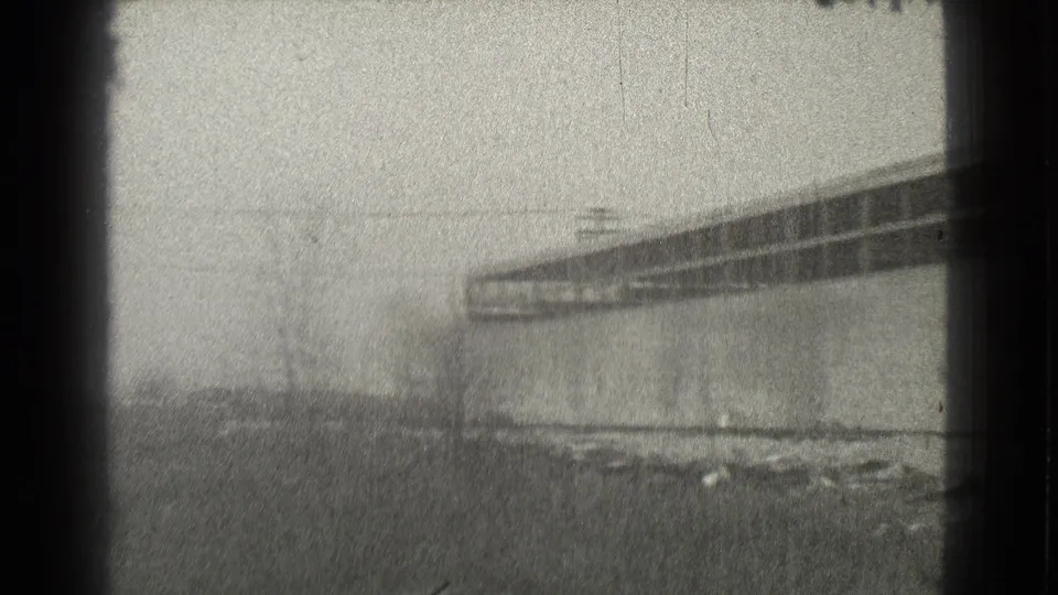 A wider 1939 Cleveland view shows a long partially built structure, open ground, and scattered construction debris in soft black-and-white 8mm footage.