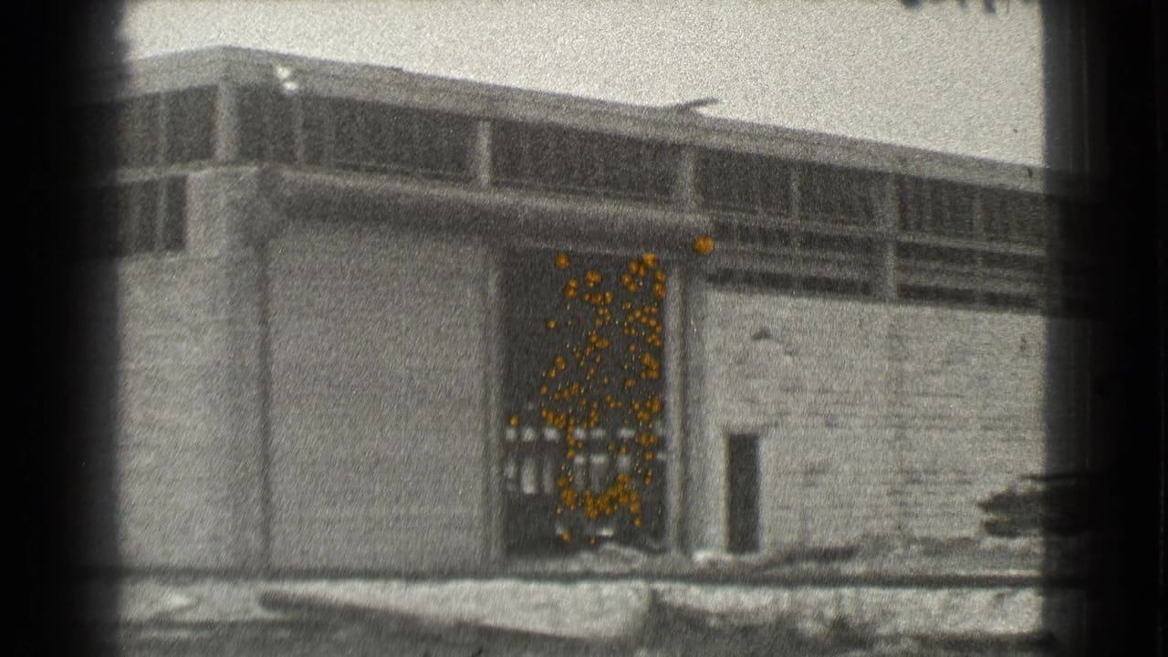 Long industrial building with an open service doorway and high windows.