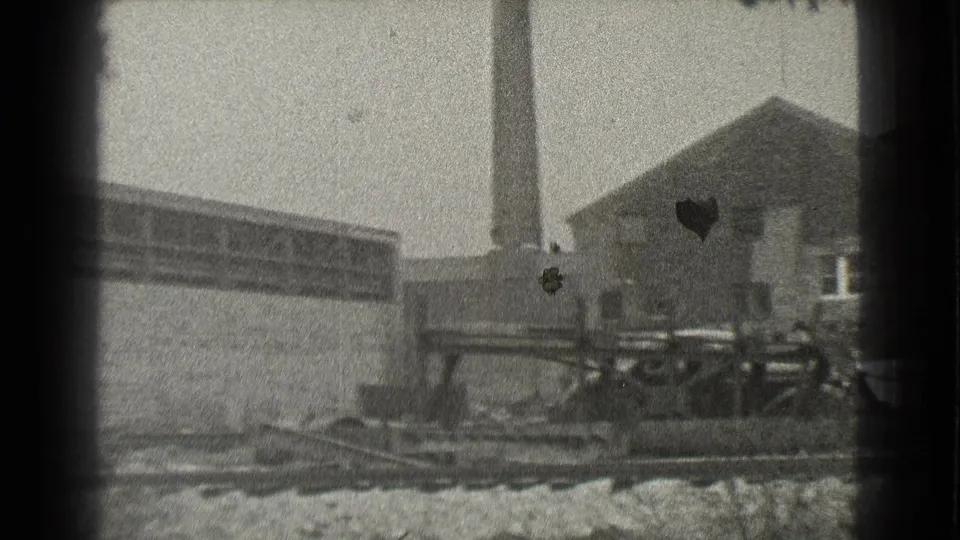 1939 Cleveland frame showing the industrial complex continuing toward a smokestack and adjacent smaller building.