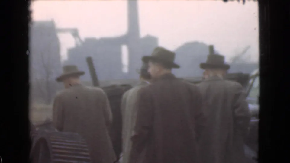 Several suited men in hats face away toward a hazy industrial skyline, likely in Cleveland based on the clip metadata.