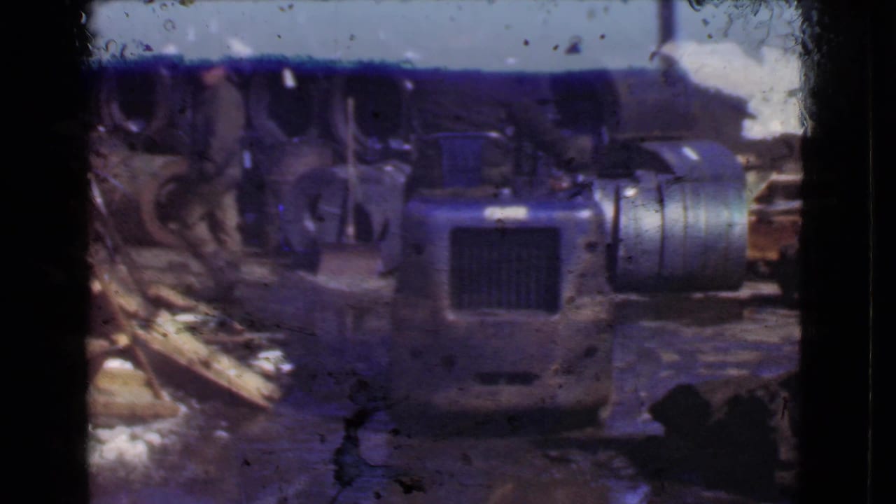 Forklift or industrial vehicle near scrap materials and stacked metal.