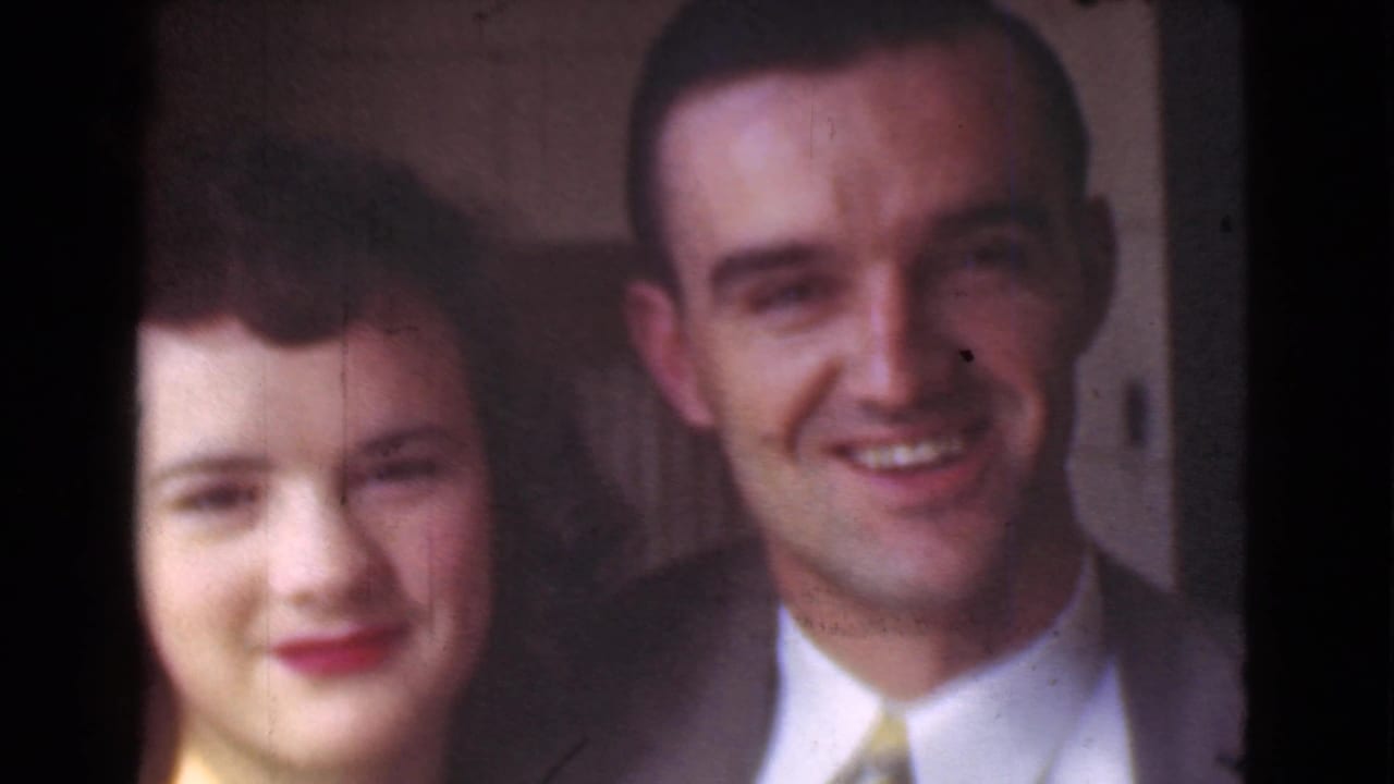Young woman and man smiling close to the camera on a city street.