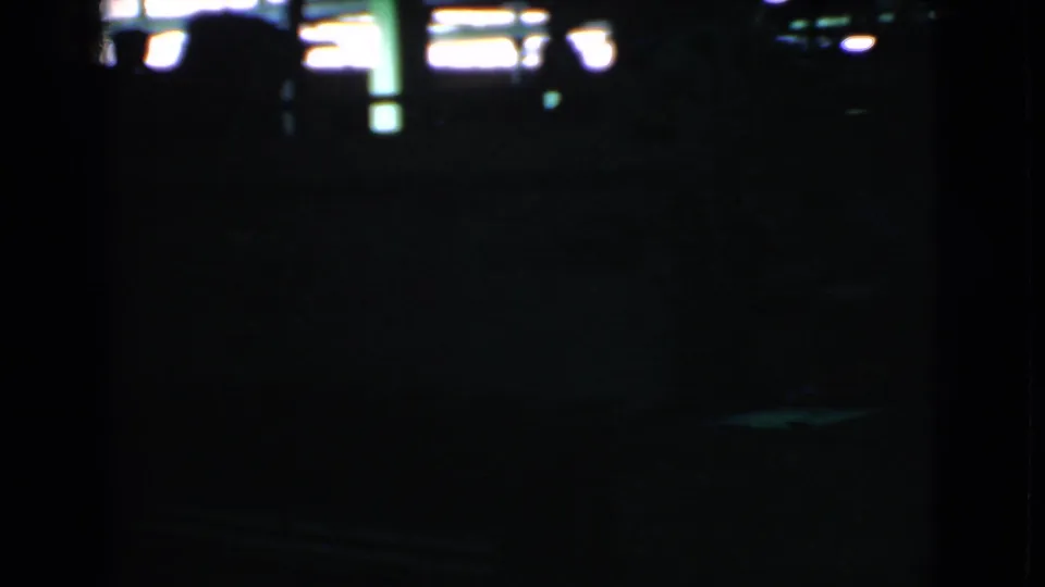 Underexposed end frame from the Cleveland street clip, with only faint window highlights and minimal visible street detail.
