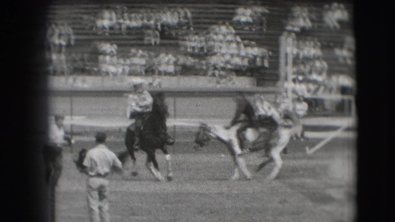 1941 Denver rodeo footage showing riders on bucking horses in an arena, with bleachers and a standing attendant visible nearby.