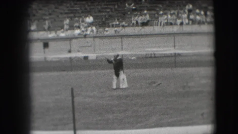Denver 1941 home-movie frame showing the clown raising both arms during a field performance.