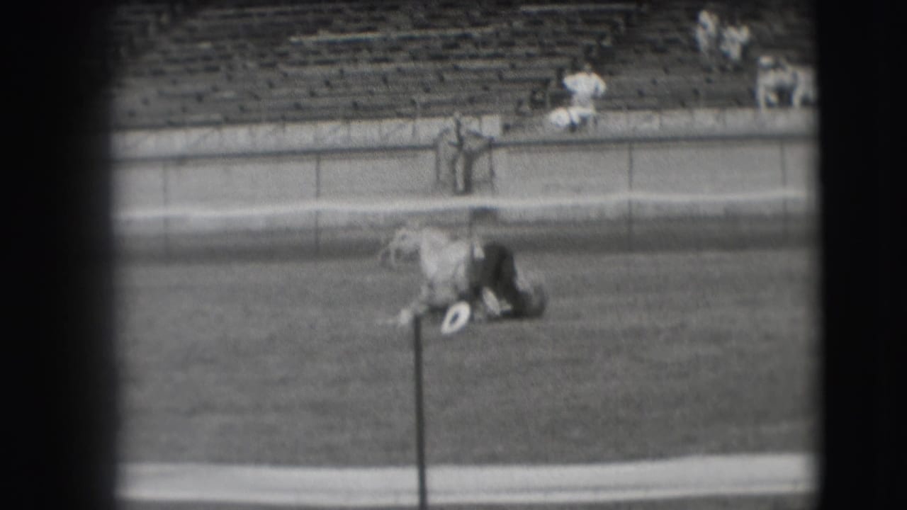 The horse comes higher off the ground as the man remains across its body in the 1941 Denver field scene.