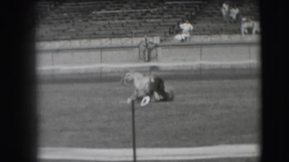 The horse comes higher off the ground as the man remains across its body in the 1941 Denver field scene.