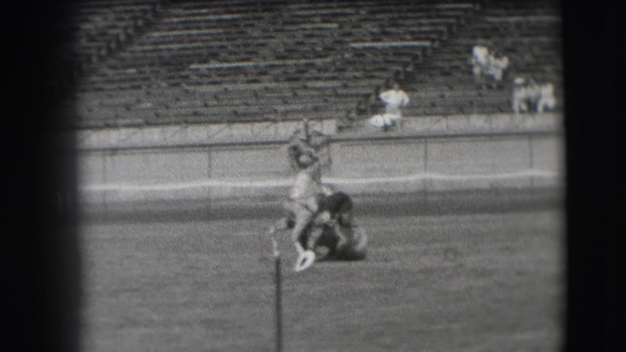 The horse appears upright with the man still across its back, filmed from a distance on a Denver grass field in 1941.