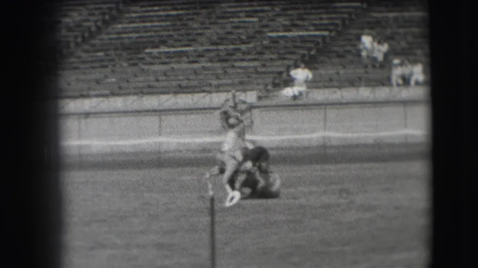 The horse appears upright with the man still across its back, filmed from a distance on a Denver grass field in 1941.