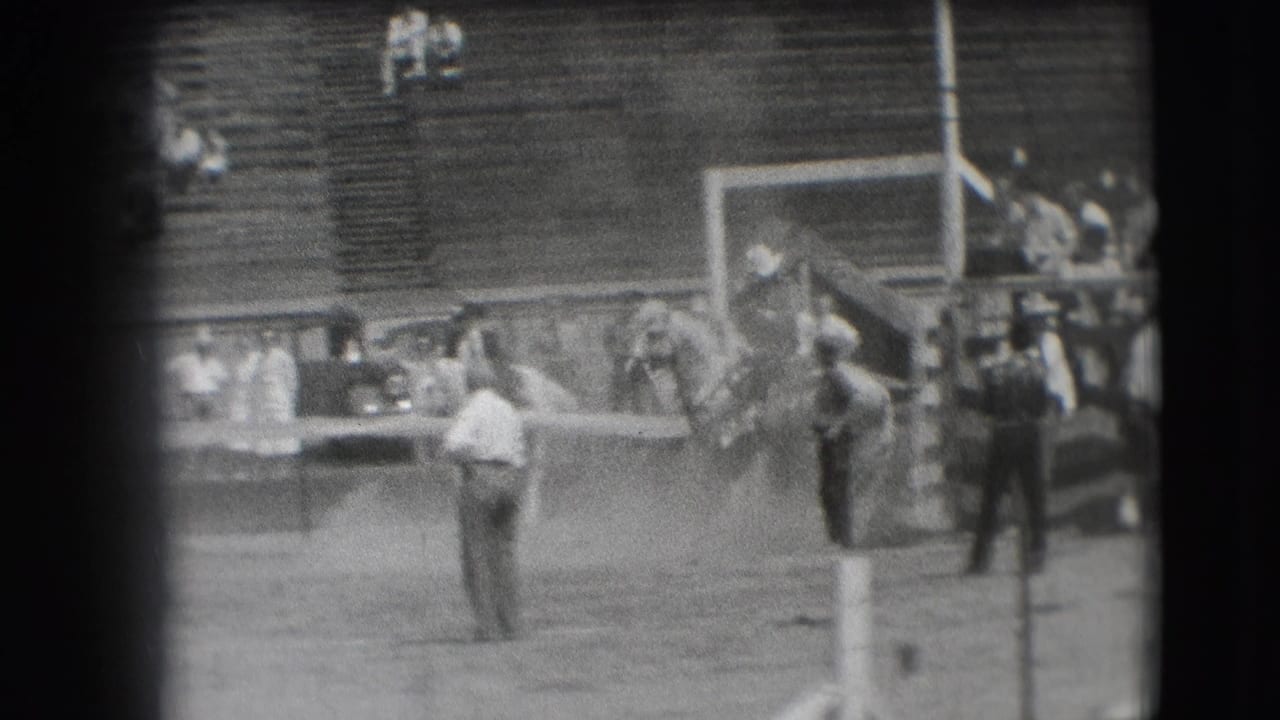Denver rodeo arena in 1941, showing people gathered near a chute area with wooden bleachers in the background.