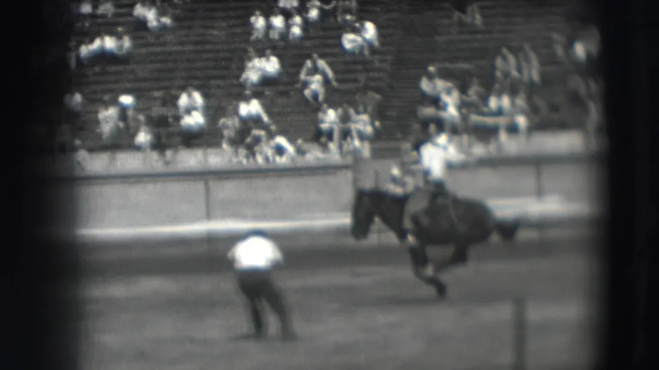 The closing frame shows the horse and rider moving along the Denver rodeo arena with spectators in the background.