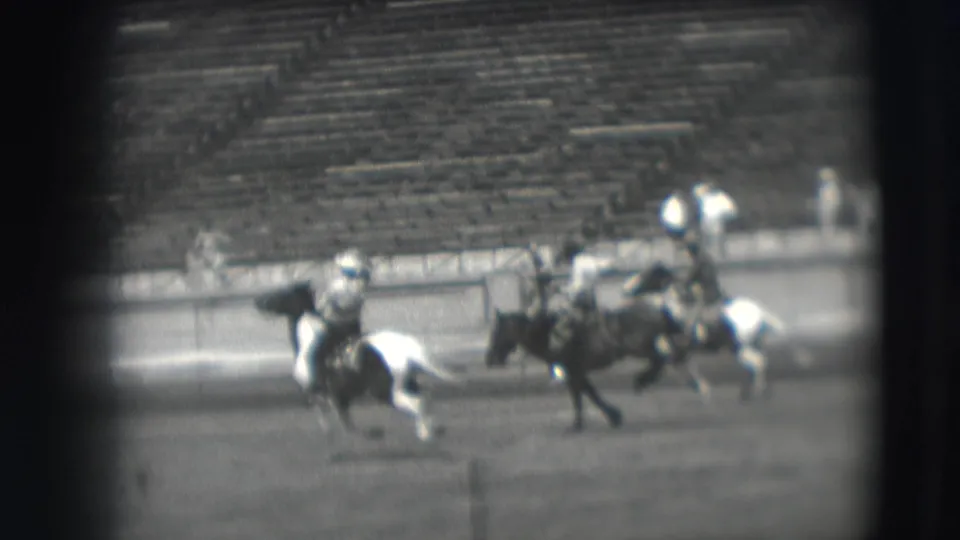 Final frame of the 1941 Denver riding competition shows multiple horses, including a pinto, moving past stadium seating.