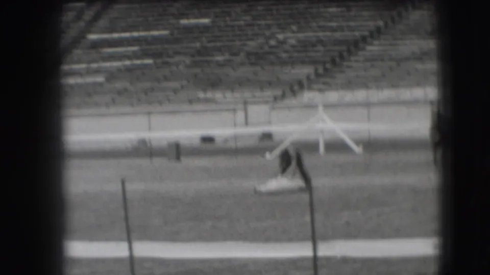 In 1941 Denver rodeo footage, a rider on horseback appears in a grass arena with tiered seating in the background.