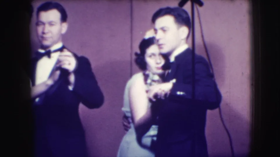 1941 Joliet frame with two adult couples dancing in formal clothing, with microphone stands visible above and beside them.