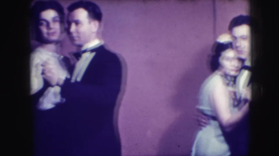 1941 Joliet 8mm frame showing two adult couples dancing, partly cropped by the contact-sheet frame and softened by blur.