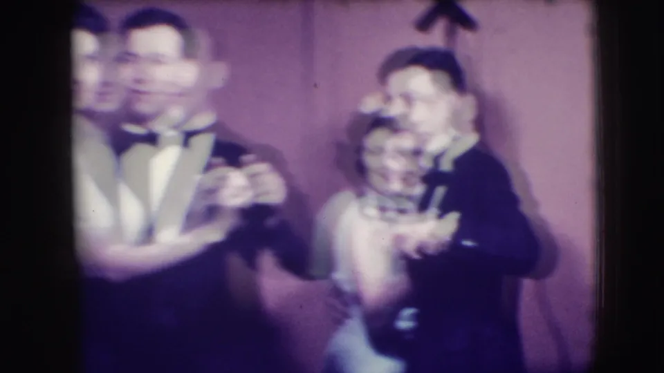 Two formally dressed couples dance in the Joliet 1941 home movie, with motion blur across the foreground pair.