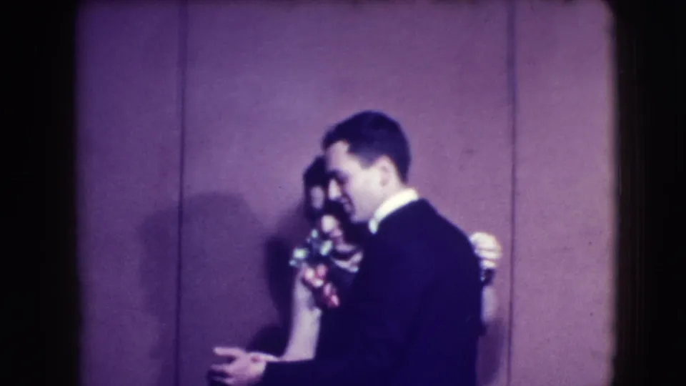 A turning moment in the Joliet 1941 home movie shows the suited man in profile as the couple keeps dancing.