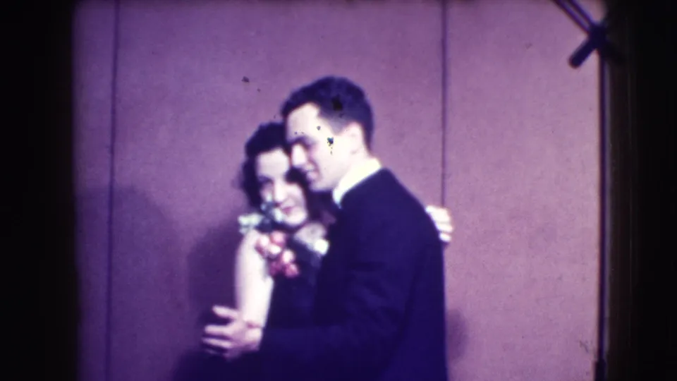 The 1941 Joliet couple remains in a close dance pose, with the woman’s flowers and the man’s dark suit visible.