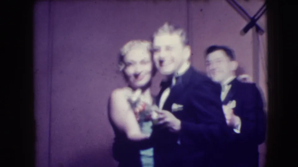 In the closing frame, two couples in 1941 Joliet formalwear smile and dance before the plain purple backdrop.