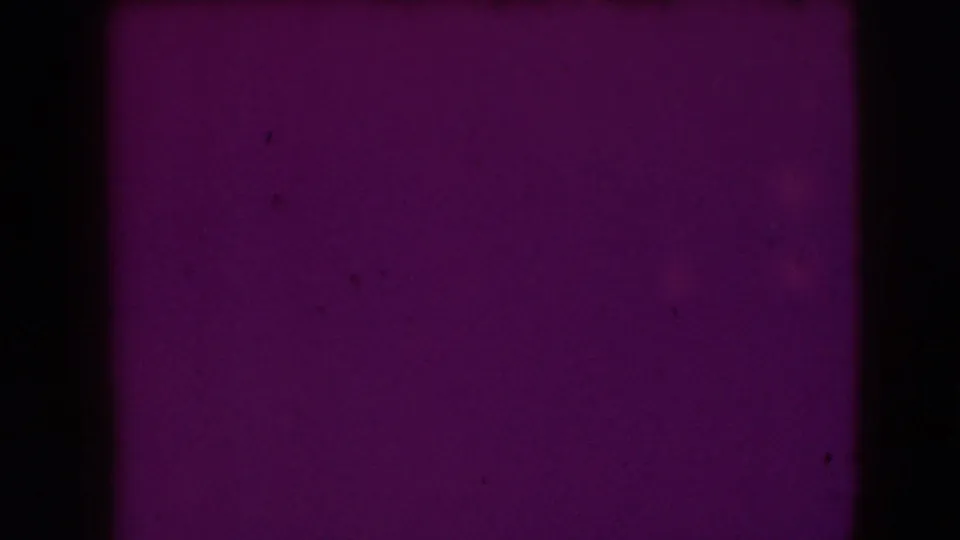 Joliet 1941 8mm frame showing a purple-tinted blank wall area with heavy gate edge and film exposure variation.