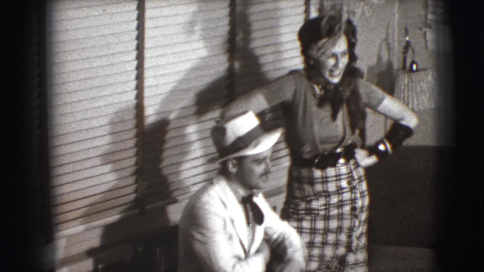 The final 1941 Joliet frame shows the man seated in profile while the woman smiles or laughs beside him near striped window-blind shadows.