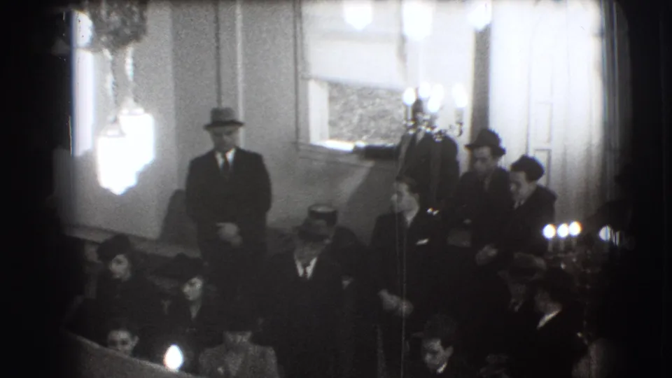 In the final frame, a suited man stands near seated participants, candles, and wall decorations during the 1941 Joliet ceremony.