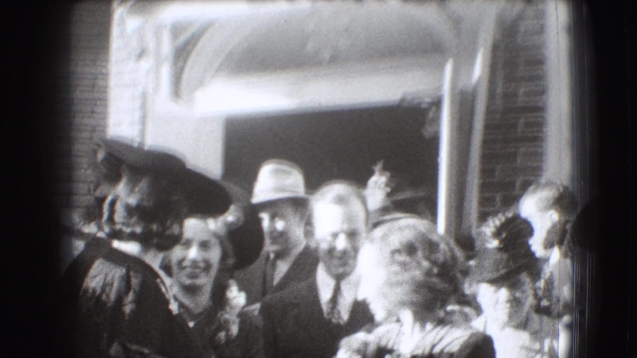 Crowd in hats and suits gathered outside a brick building entrance.