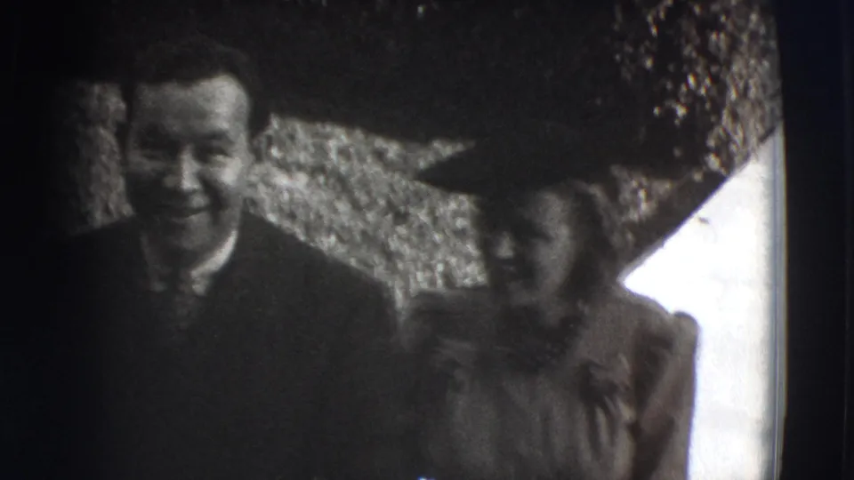 At the end of the 1941 Joliet sidewalk shot, the couple smiles close to the home-movie camera in a high-contrast black-and-white frame.