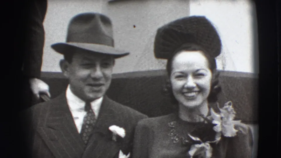 1941 Joliet frame showing the couple smiling at the camera after a brief affectionate moment.