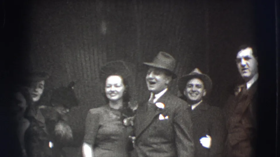 A 1941 Joliet gathering shows formally dressed adults smiling together, including men in suits and hats and a woman in a dress.
