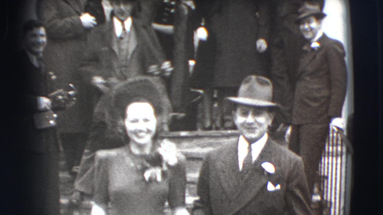 Smiling couple walking from church steps with guests behind them.