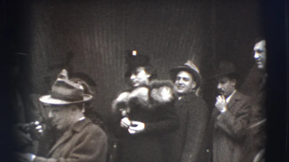 A Joliet queue scene shows adults in formal outerwear, a woman with a fur stole, and men in hats, one smoking near the group.