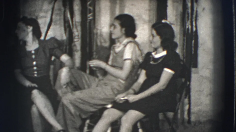 Young women in 1941 Joliet, Illinois sit in an outdoor home setting, one gesturing during conversation.