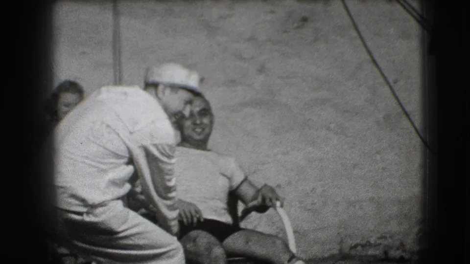 The final Joliet frame shows a sailor leaning toward a smiling seated man, with a plain wall and studio stand visible behind them.