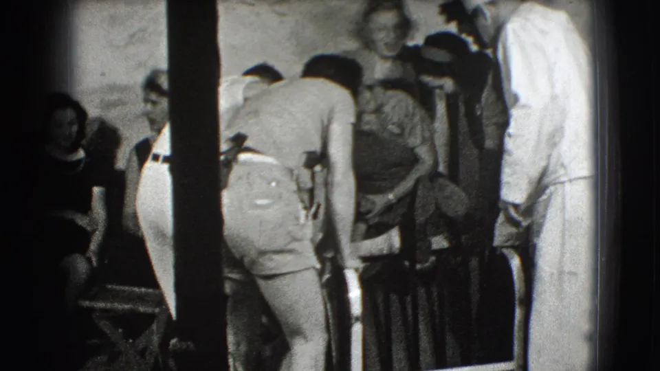 The final frame shows adults clustered near railings or deck equipment, with the sailor partly visible at the edge and faces turned toward the activity.