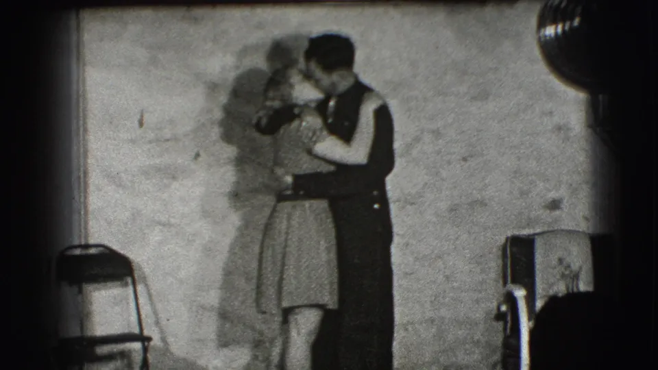 The 1941 Joliet home-movie scene continues with the couple dancing in close embrace inside the private-looking room.