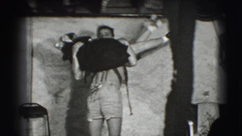 The couple continues the playful lift in the 1941 Joliet interior, with the woman's arm extended toward the frame edge.
