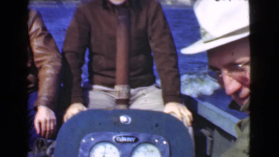The boat scene shifts to a closer crop of the seated men, with an older man in a white hat partly visible at the right edge.