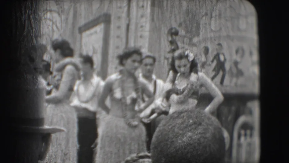 Costumed women and men at the 1948 Sarasota Ringling Brothers scene stand near a painted tropical mural backdrop.