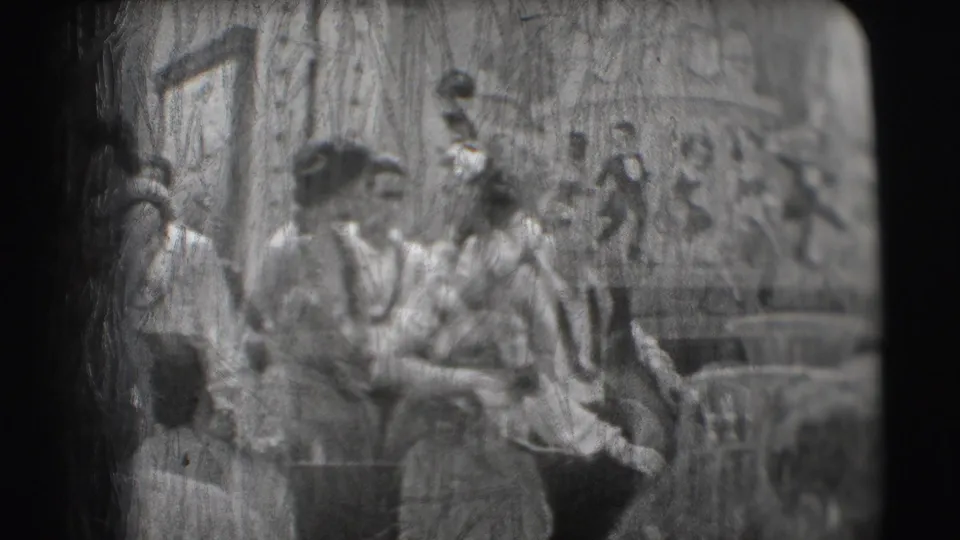 Tropical-costumed performers and musicians appear in a soft 8mm frame at the Ringling Brothers Sarasota setting.