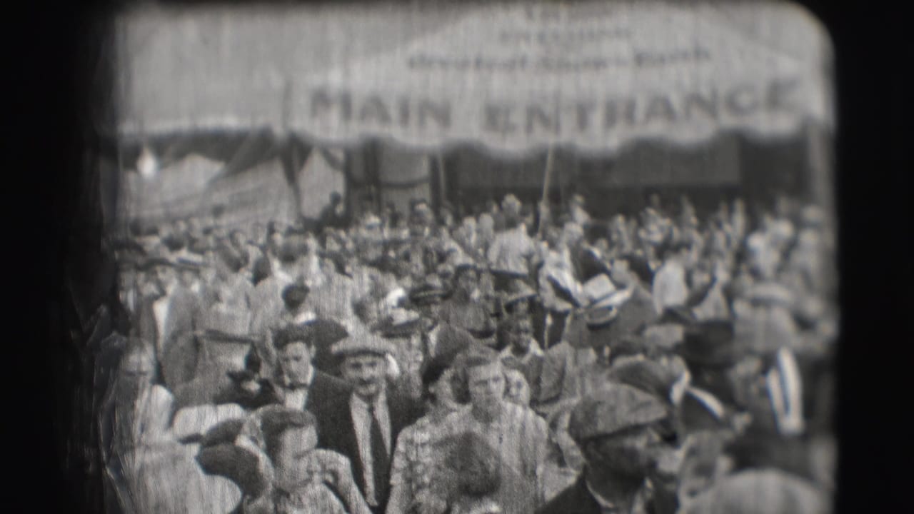 1948 Sarasota circus crowd beneath a large canvas awning marked MAIN ENTRANCE, with many adults in hats visible.