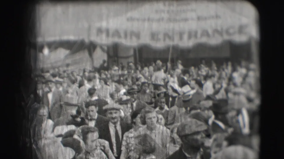 1948 Sarasota circus crowd beneath a large canvas awning marked MAIN ENTRANCE, with many adults in hats visible.