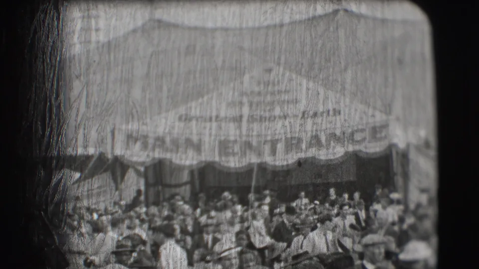 A softer 8mm frame shows the Sarasota circus entrance awning and a crowd gathered below the partially legible MAIN ENTRANCE sign.