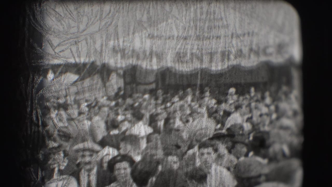 Crowd gathered beneath a circus entrance canopy, with many adults in hats.